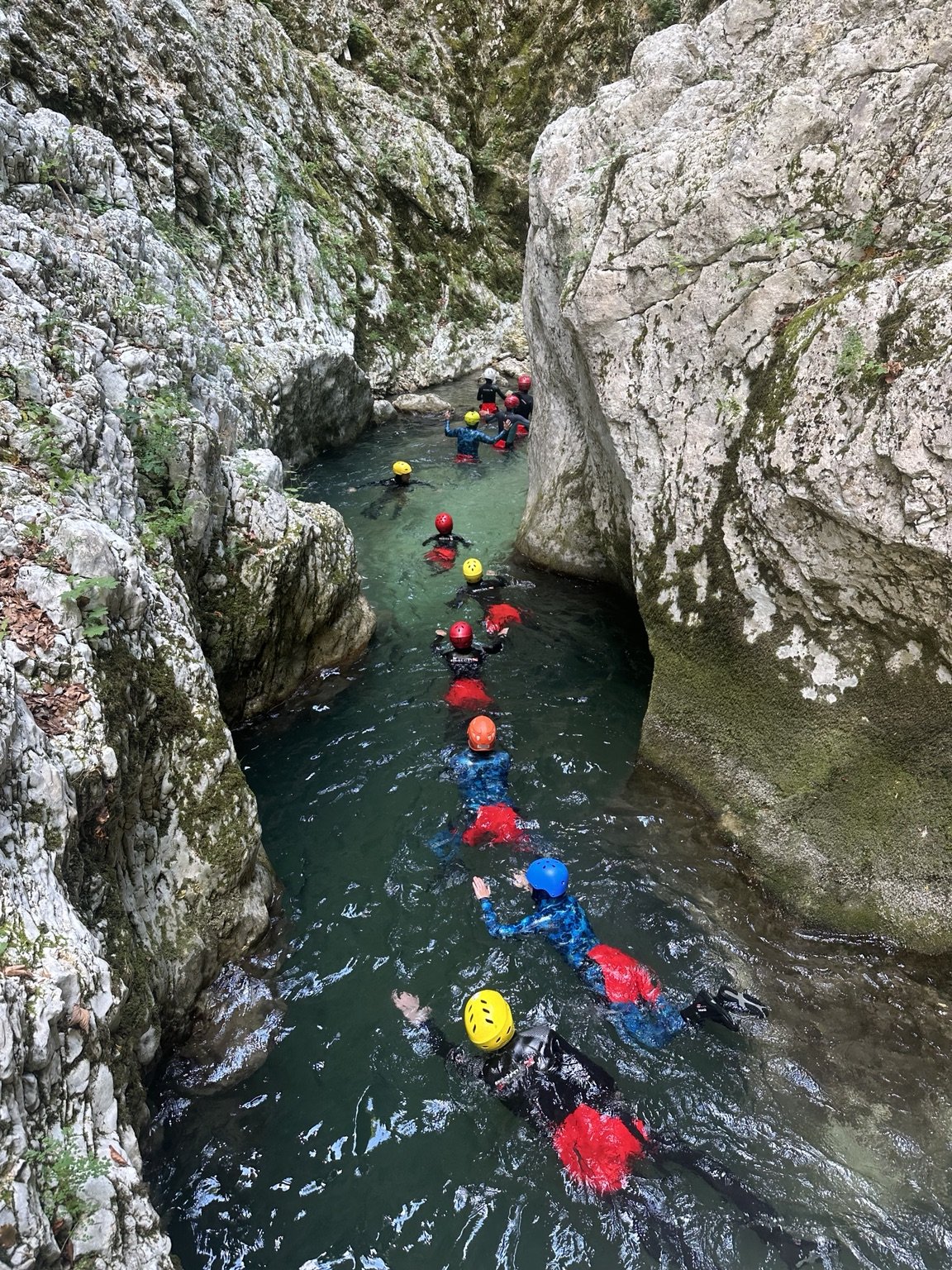 Canyoning group in a narrow rocky gorge