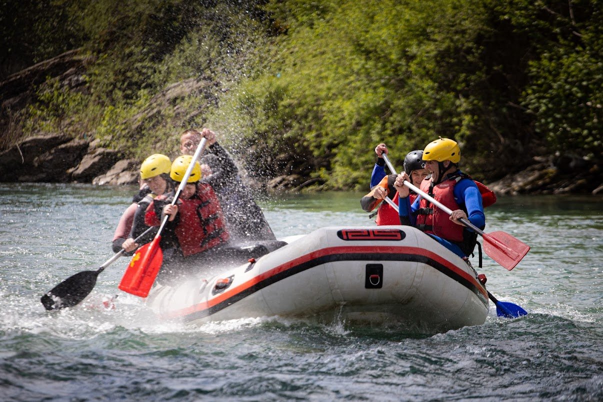 Rafting group paddling through white water